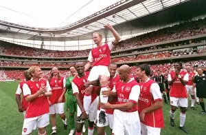 Stadium Art Collection: Dennis Bergkamp is chaired by Patrick Vieira and Thierry Henry and the rest of the Arsenal Legends
