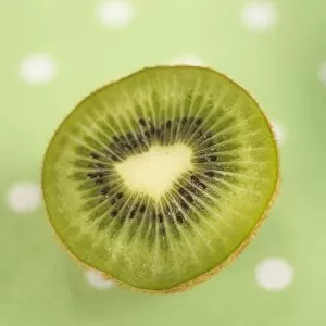 Food and Drink Framed Print Collection: Half cut kiwi fruit on green polka dot tablecloth