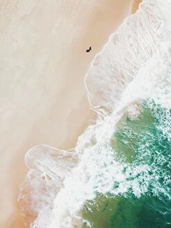 Australia Photographic Print Collection: An aerial beach shot of guy walking on the beach and the waves breaking on the shore