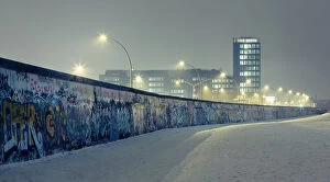 German Culture Collection: Berlin wall at winter with mist an nightlights