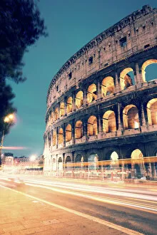 Colosseum Collection: Colosseum at night with light trails from cars