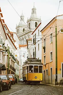 Portugal Photo Mug Collection: Famous yellow tram on the narrow streets of Alfama district, Lisbon, Portugal