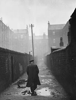 Glasgow Metal Print Collection: A man walking through a backstreet of the Gorbals area of Glasgow