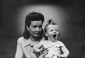 Single Mother Collection: Studio shot of woman with yawning baby girl (6-11 months)