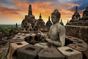 Related Images Photographic Print Collection: Sunrise with a Buddha Statue with the Hand Position of Dharmachakra Mudra in Borobudur, Magelang