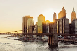 Brooklyn Bridge Canvas Print Collection: Sunset over Brooklyn Bridge and skyline of Manhattan Financial District in Downtown