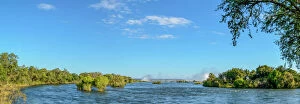 Photograph Collection: Zambezi River view with the spray from Victoria Falls in the distance. Livingstone. Zambia