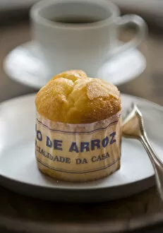 Food Photography Collection: Classic Portuguese muffin type cake made with rice in paper wrapper on metal plate