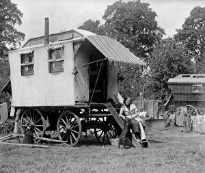 Related Images Collection: A gypsy woman sitting on the steps to her Romany caravan in the gypsy camp on Epsom Downs