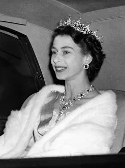 Monarch Collection: Queen Elizabeth II jewels glittering in her hair and at her throat arrives at Swedish
