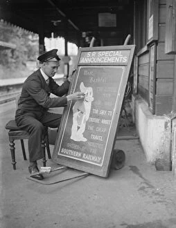 Railway Posters Photographic Print Collection: Railway porter sign writer Mr E A Burgar. 1938