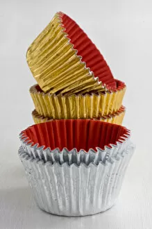 Food Photography Collection: Stack of decorative metallic foil cake and muffin cases credit: Marie-Louise Avery