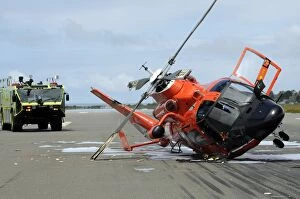 Bad Condition Collection: A U. S. Coast Guard MH-65 Dolphin helicopter lays on its side after it crashed at