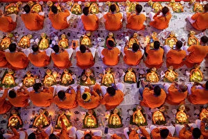 Monks Collection: Devotees pray with light