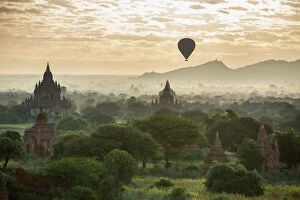 Sunrise landscapes Photo Mug Collection: Hot air balloon over the Temples of Bagan at dawn, Myanmar, November 2012
