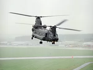 Chinook Collection: A Chinook of 27 Sqn based at RAF Odiham photographed flying low over an airfield in Scotland