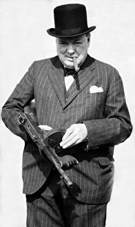 Politicians Canvas Print Collection: British Prime Minister Winston Churchill holding a Thompson submachine gun whilst smoking