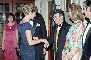 Entertainment Poster Print Collection: HRH Princess Diana, Princess of Wales is greeted by singer Elton John for a charity