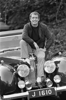 Film Collection: John Nettles, actor, pictured on the set of Bergerac. He is sitting on the car his