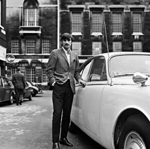 Moustaches Collection: Manchester United footballer George Best beside his car. October 1967