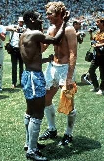 Pele Photographic Print Collection: Pele of Brazil and Bobby Moore of England exchange shirts after the World Cup Group C