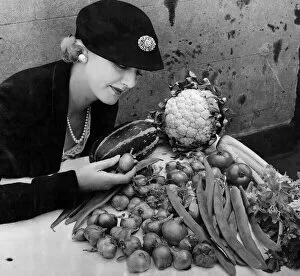 Celery Collection: A woman with a selection of vegetables, some of which can be used for pickling